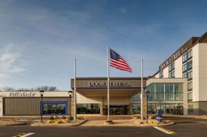an american flag flying in front of a building at Doubletree By Hilton Madison East in Madison