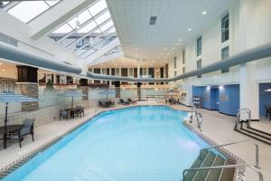 a large swimming pool in a large building at Doubletree By Hilton Madison East in Madison