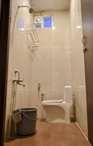 a bathroom with a toilet and a shower stall at DKV Beach View in Bahūr