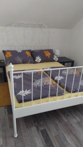 Una cama blanca con dos almohadas encima. en KETI, en Plaški