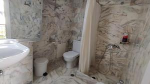 a bathroom with a toilet and a sink at Vaporia in Ermoupoli