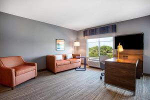 a living room with a couch and a chair at Hampton Inn & Suites North Port, Fl in North Port
