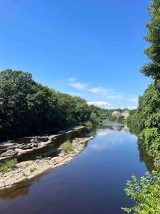 a river with trees on the side of it at Stunning Barn, Bowes, Barnard Castle in Barnard Castle