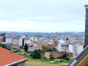 a view of a city from the roof of a building at Casa Nicolas in Chantada
