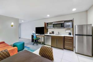an apartment kitchen with a refrigerator and a desk at Home2 Suites by Hilton Minneapolis Downtown in Minneapolis