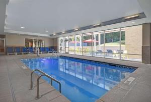 a large swimming pool in a hotel lobby at Home2 Suites By Hilton Raleigh North I-540 in Raleigh