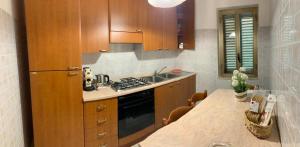 a kitchen with wooden cabinets and a counter top at Il Ciliegio in Stella Cilento