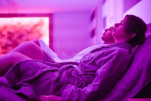 a man and woman laying on a bed in a room at Bella Hotel & Restaurant with private dock for mooring boats in San Felice del Benaco