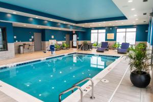 a pool in a hotel lobby with blue walls at Hampton Inn Paris IL, IL in Paris