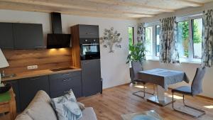 a living room with a kitchen and a table at Haus Bergblick in Altaussee