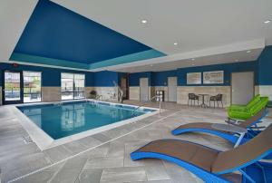 - une piscine dans une chambre d'hôtel aux murs bleus dans l'établissement Hampton Inn Cave City, KY, à Cave City