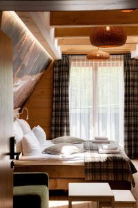 a bedroom with a large bed with a window at Ku Dolinie in Kościelisko