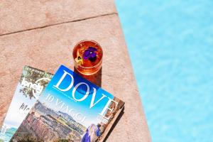 a book sitting on a table next to a magazine at Bella Hotel & Restaurant with private dock for mooring boats in San Felice del Benaco