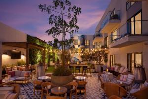a hotel patio with couches and tables and chairs at The Monsaraz San Diego, Tapestry Collection By Hilton in San Diego