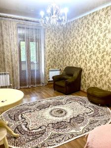 a living room with a couch and a rug at Майлина 10 аэропорт in (( Turksib ))