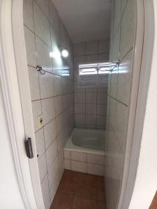 a small bathroom with a tub and a shower at Recanto Boa Vista in Joinville