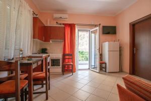 a kitchen with a table and a refrigerator at Pigeon House in Plataria
