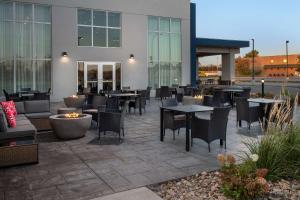 a patio with tables and chairs in front of a building at Hampton Inn Warroad, MN in Warroad