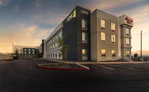 a building with a tree in a parking lot at Hampton Inn Riverside March Air Force Base, Ca in Riverside