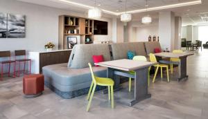 a waiting room with chairs and tables and a couch at Hampton Inn Riverside March Air Force Base, Ca in Riverside