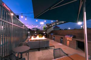 a patio with a fire pit on a rooftop at night at Hampton Inn Riverside March Air Force Base, Ca in Riverside