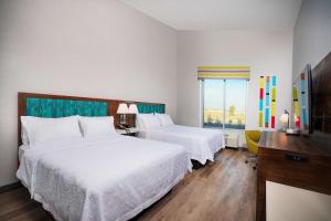 a hotel room with two beds and a window at Hampton Inn Riverside March Air Force Base, Ca in Riverside