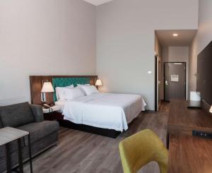 a hotel room with a bed and a couch at Hampton Inn Riverside March Air Force Base, Ca in Riverside
