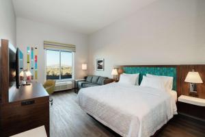 a hotel room with a large bed and a television at Hampton Inn Riverside March Air Force Base, Ca in Riverside +16 photos