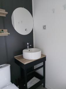 a bathroom with a sink and a mirror at Camping Taimì in Marina di Massa
