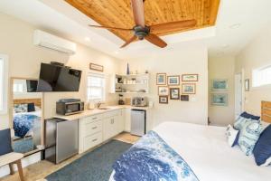 a bedroom with a bed and a ceiling fan at Unique Boathouse on the Bay in Kaneohe