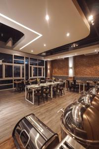 a restaurant with tables and chairs in a room at Istanaku in Manado