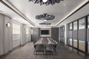 a conference room with a long table and chairs at Canopy By Hilton Portland Waterfront in Portland
