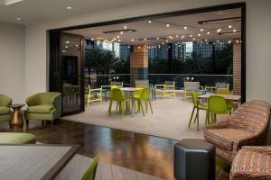 a restaurant with tables and chairs and a patio at Home2 Suites by Hilton Orlando Downtown, FL in Orlando