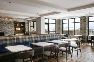 a restaurant with tables and chairs and windows at Homewood Suites By Hilton Dillon in Dillon