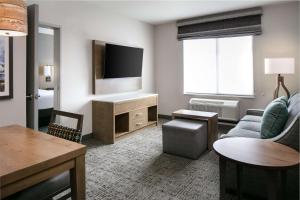 a living room with a couch and a tv at Homewood Suites By Hilton Dillon in Dillon