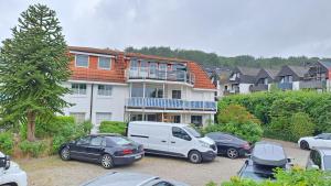 a van parked in a parking lot in front of a house at Appartement Fördetraum am Strand von Wassersleben App 9 in Harrislee