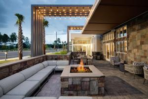 a patio with a fire pit in front of a building at Hilton Garden Inn Panama City Airport, Fl in Panama City