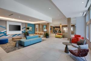 a lobby of a hospital with colorful furniture at Hilton Garden Inn Panama City Airport, Fl in Panama City