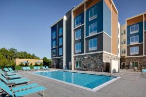 a swimming pool in front of a building at Hilton Garden Inn Panama City Airport, Fl in Panama City