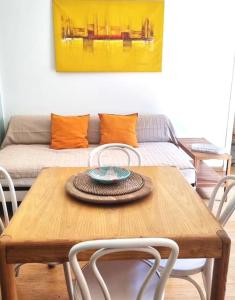 a table with chairs and a couch in a living room at Casa Pellico in Turin