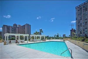 a swimming pool with a gazebo in a city at KING BED, Spacious, Legal, VIEW in Honolulu