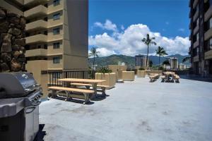 a patio with a picnic table and a grill at KING BED, Spacious, Legal, VIEW in Honolulu