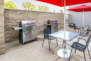 a patio with a grill and tables and chairs at Home2 Suites By Hilton West Sacramento, Ca in West Sacramento