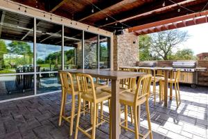 a patio with a wooden table and chairs at Home2 Suites By Hilton Lincolnshire Chicago in Lincolnshire
