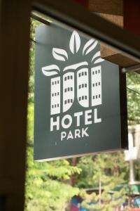 a sign for a hotel park on a window at Hotel Park in Prishtinë