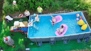 a group of people playing in a swimming pool at Gästehaus Nachtigall 2 in Gädheim