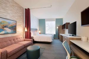 a hotel room with a couch and a bed at Home2 Suites By Hilton Phoenix Avondale, Az in Avondale