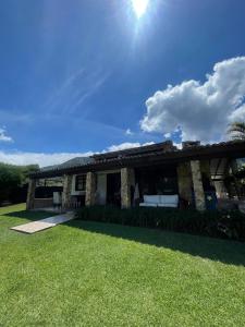 a house with a green lawn in front of it at Finca Colonial / Lago Calima in Calima