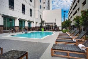 a swimming pool in a building with chairs and a pool at Home2 Suites by Hilton Houston Medical Center, TX in Houston