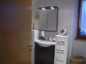 a bathroom with a sink and a mirror at Bel appartement de charme de 70 m2 in Thannenkirch +15 photos